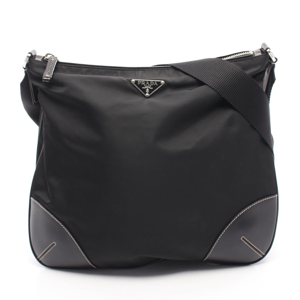 Prada Tessuto Light Shoulder Bag: Authentic and authenticated Prada TESSUTO LIGHT shoulder bag in black nylon and leather. Model BT0326. Approx. 28H x 29/31W x 5D cm with 99-105 cm strap. Includes guarantee card with description.