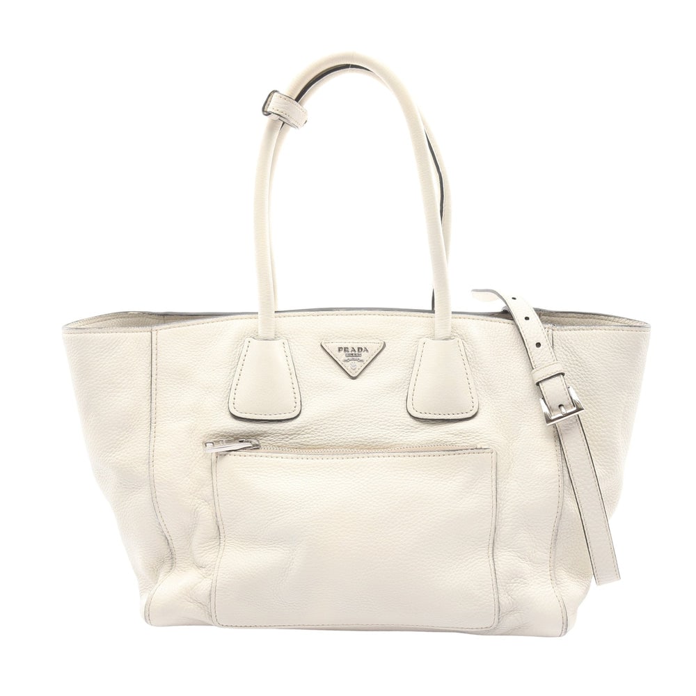 Prada Off White Leather 2WAY Bag: Authentic and authenticated Prada 2WAY handbag in off white leather. Approx. 27H x 46/30.5W x 16D cm with 49 cm handle and 107-117 cm strap. Includes shoulder strap.
