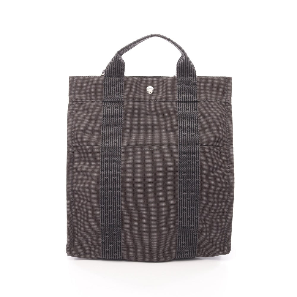 Hermes Yell Line Ado MM Backpack: Authentic and authenticated Hermes Yell Line Ado MM backpack in dark gray nylon canvas with silver hardware. Approx. 33H x 32W x 12D cm with 49-87 cm straps and 25 cm handle.