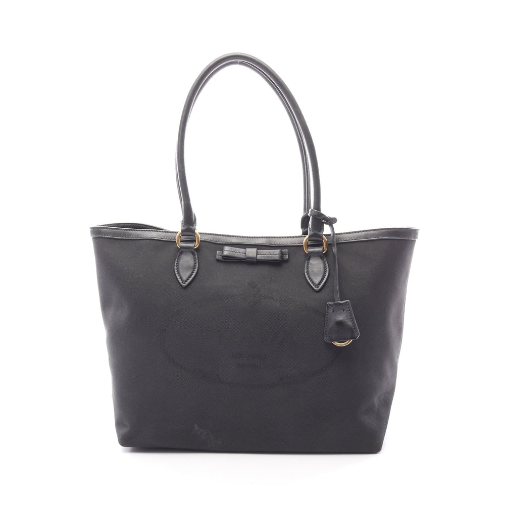 Prada Logo Jacquard Ribbon Tote: Authentic and authenticated Prada Logo Jacquard shoulder tote bag in black canvas leather with ribbon detail. Model 1BG158. Approx. 27H x 41/30.5W x 15D cm with 52 cm strap. Includes crochet with key