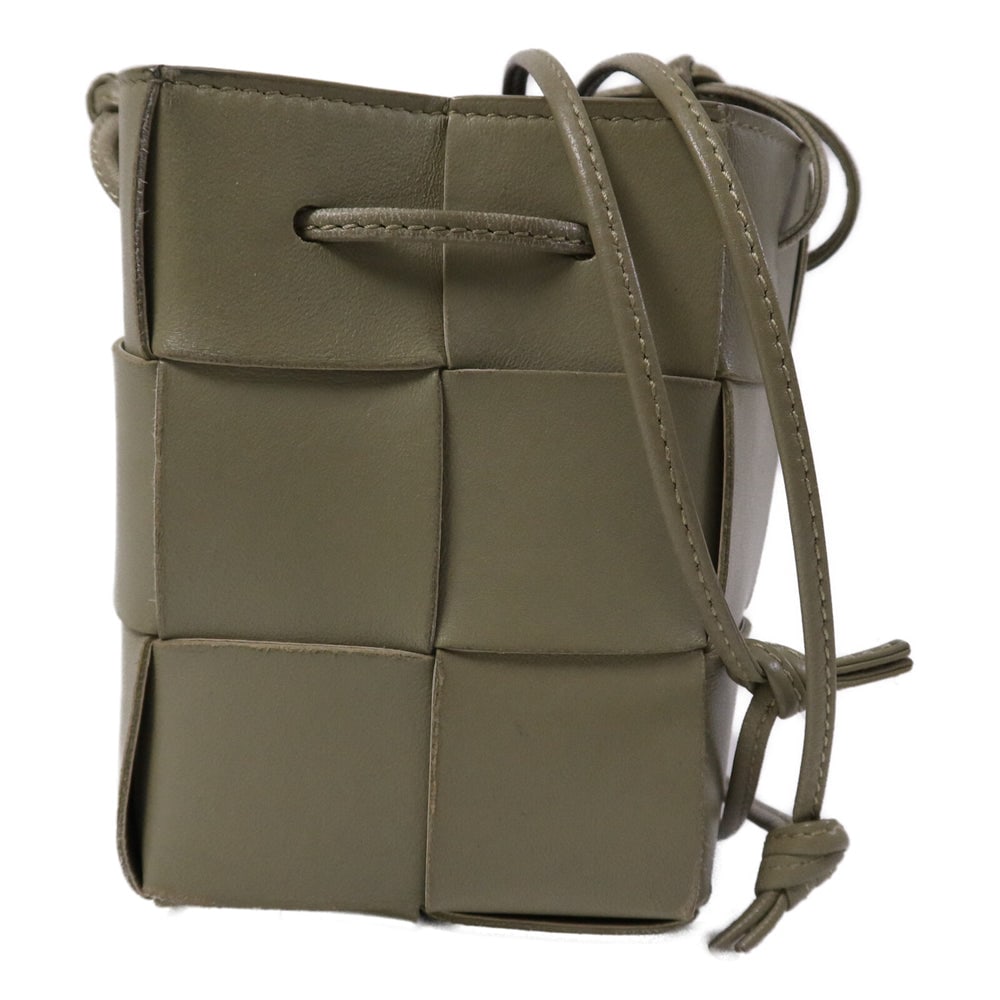 Bottega Cassette Bucket Bag Khaki: Authentic and authenticated Bottega Veneta Small Cassette Bucket shoulder bag in khaki green calfskin. Product no. 680217VCQC4. Approx. 9W x 13.5H x 9D cm with 110 cm strap. Includes storage bags.