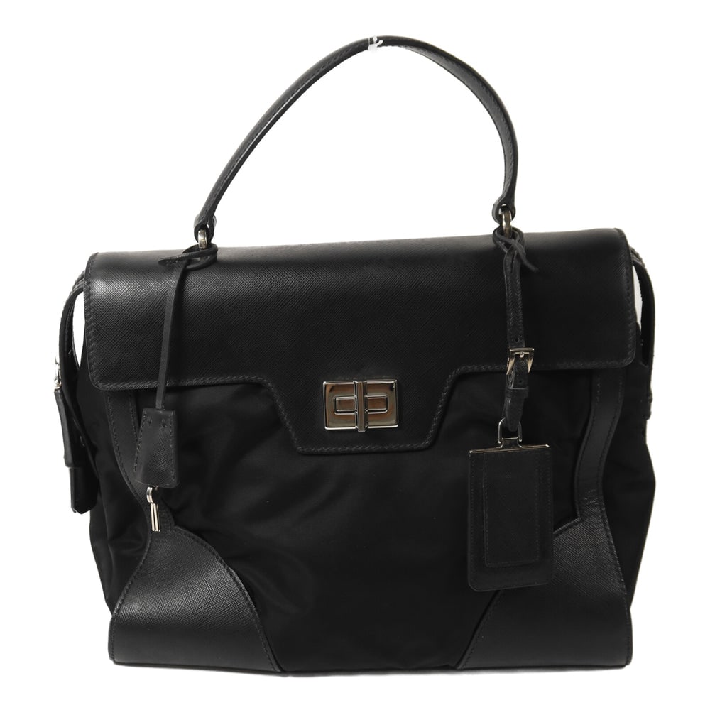 Prada Nylon Handbag Black: Authentic and authenticated Prada handbag in black nylon. Approx. 33W x 27H x 15.5D cm with 34 cm handle. Includes guarantee, clochette, key, padlock, and name tag.