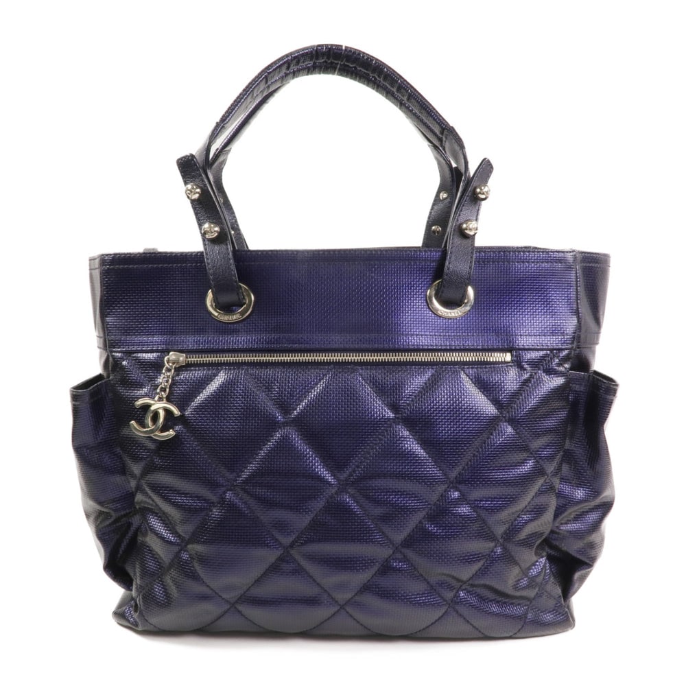 Chanel Paris Biarritz Tote Purple: Purple PVC coated canvas Chanel Paris Biarritz tote bag with hologram sticker and pouch. Approx. 35 x 30 x 15 cm; handle 51 cm. Product no. #13132774. Authentic and authenticated.