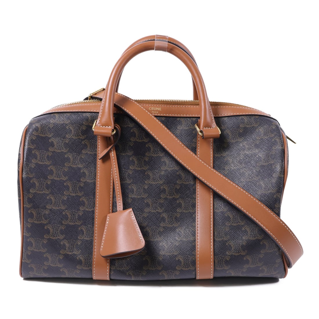 Celine Large Boston Triomphe: Large Boston in Triomphe 2 way shoulder bag in brown coated canvas. Includes storage bags, shoulder strap, key, and padlock. Size 31 x 18 x 18 cm.