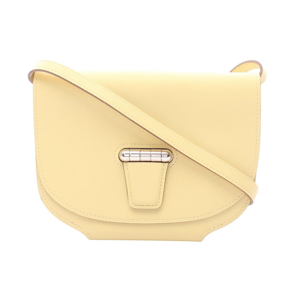 Hermes Mini Convoyeur Yellow: Light yellow Veau Swift Hermes Mini Convoyeur shoulder bag with silver hardware. Approx. 15 x 11.5 x 2 cm; strap 130 cm. X stamp, around 2016. Authentic and authenticated.
