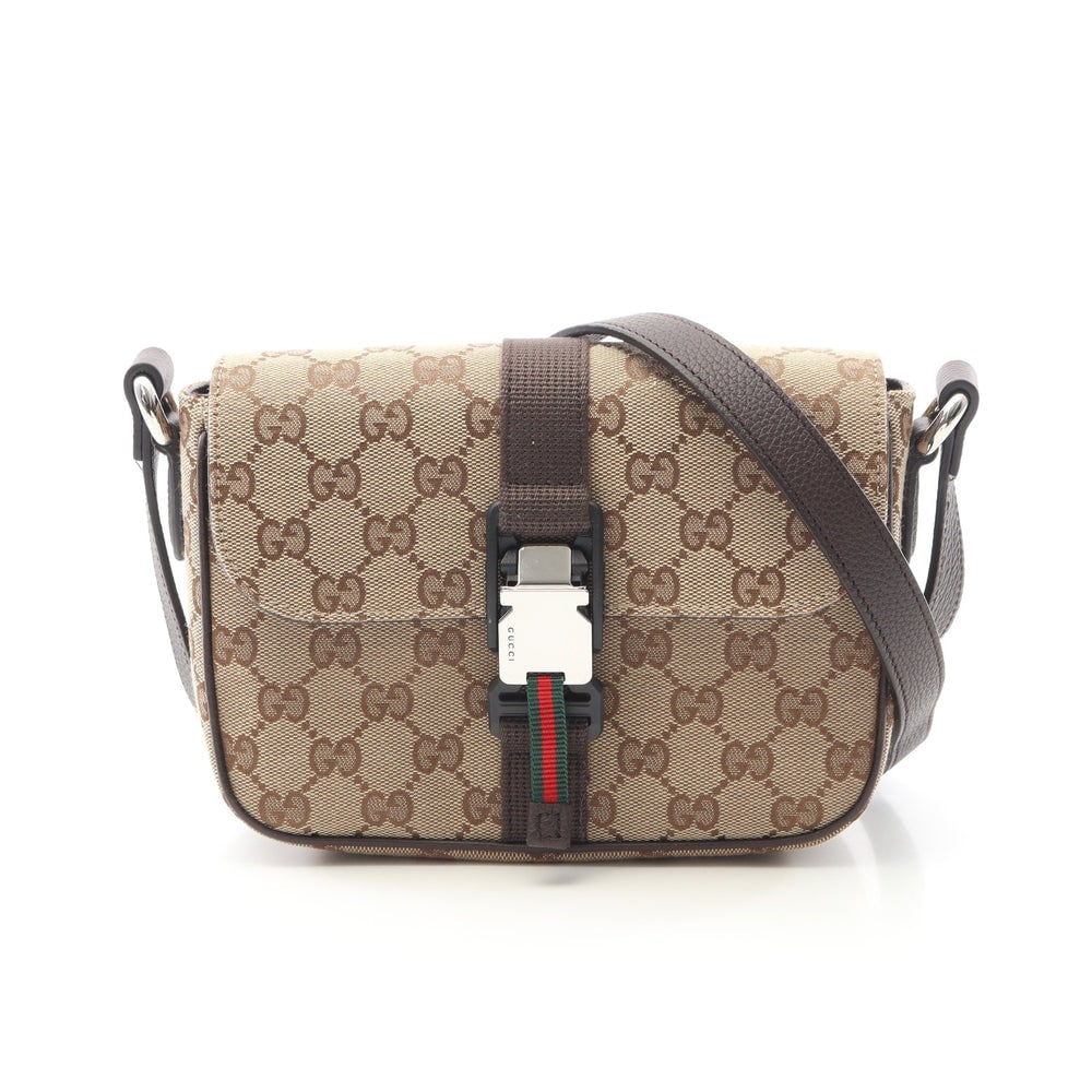 Gucci GG Mini Crossbody Beige: Beige and dark brown canvas and leather GG mini crossbody shoulder bag with box and storage bags. Approx. 20 x 14 x 7 cm; strap 119-130 cm. Model 802100FADUS9857. Authentic and authenticated.