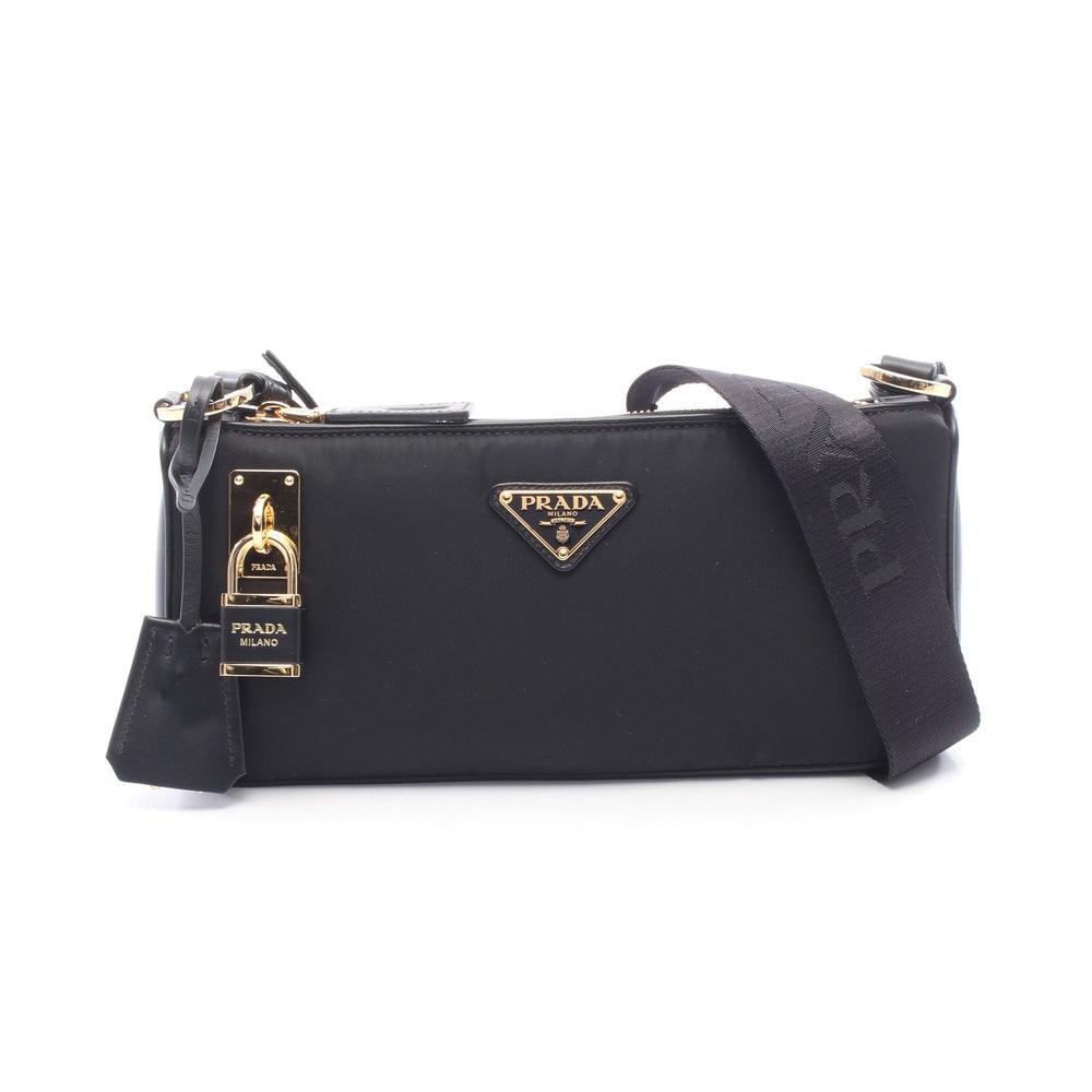 Prada Re-Nylon Small Bag Black: Black nylon and leather small shoulder bag. Includes storage bags padlock keys and crochet. 27 x 13 x 3.5 cm.