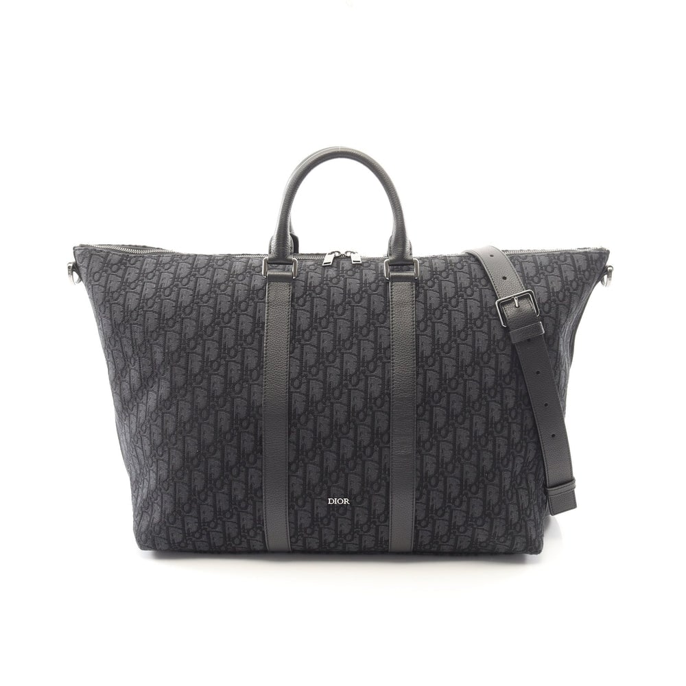 Dior Weekender 40 Boston Bag: Black Oblique jacquard canvas and leather 2 way Boston bag; includes shoulder strap; H32 x W58/42 x D22 cm. Authentic and authenticated.