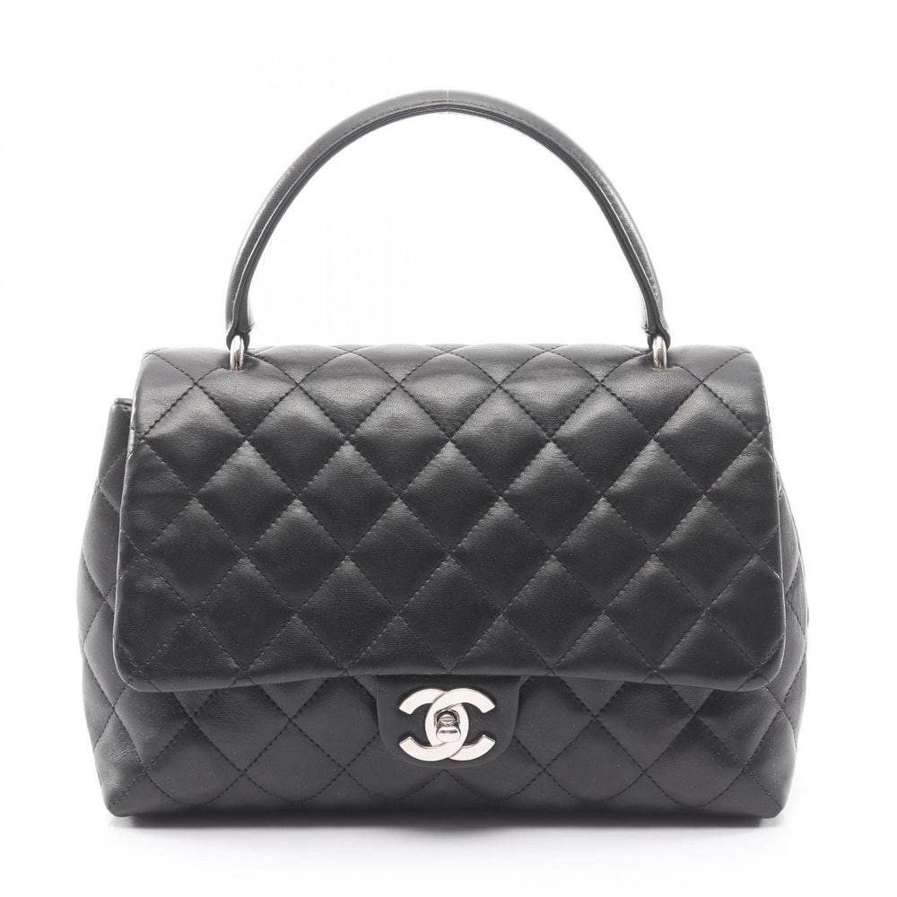 Chanel Top Handle Bag Black: Black lambskin top handle handbag with silver-tone hardware.