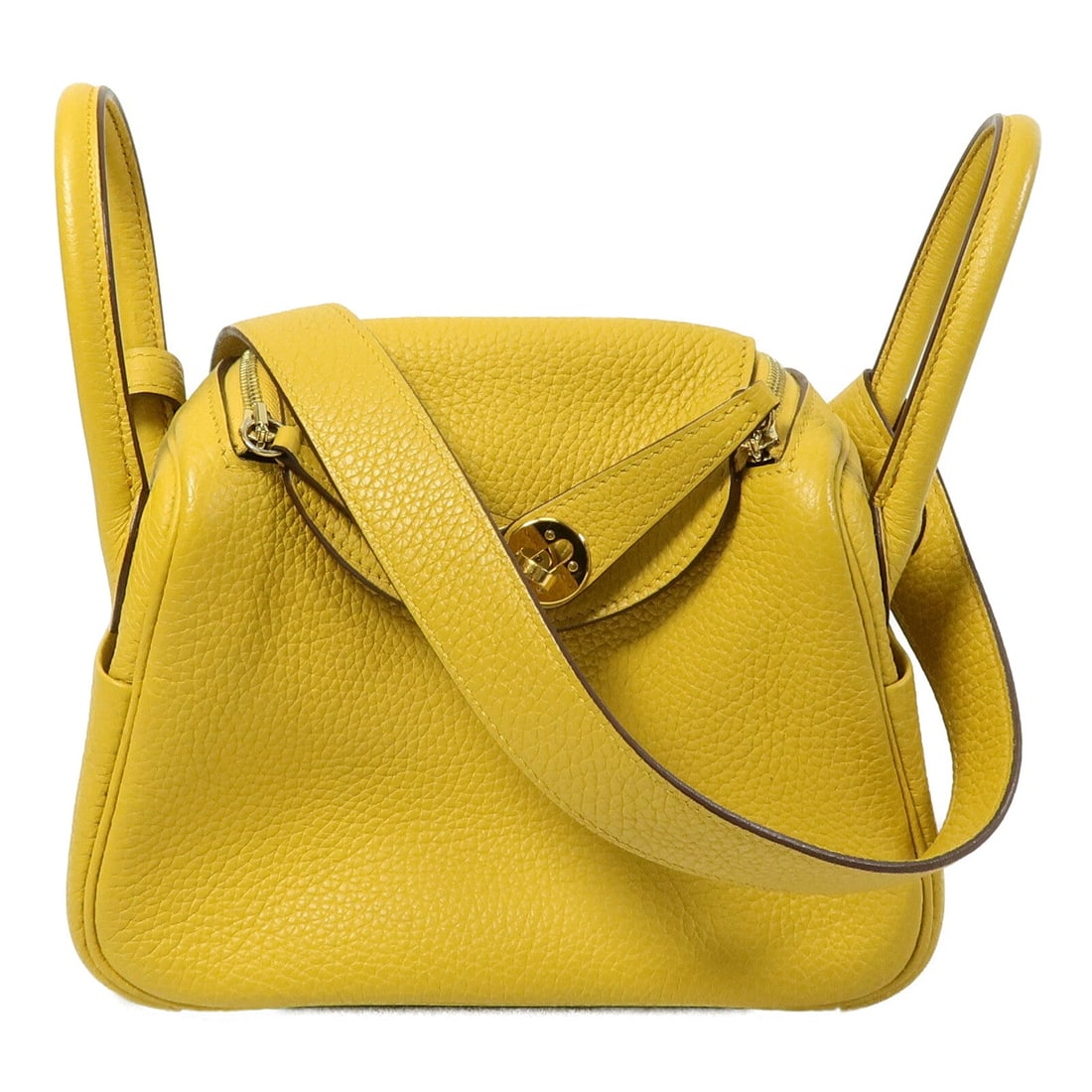 Hermes Mini Lindy Jaune Ambre: Authentic and authenticated Hermes Mini Lindy 2Way shoulder bag in Jaune Ambre Taurillon Clemence calfskin. Approx. 20W x 13H x 9D cm with 22 cm handle. Includes box, storage bags, and rain cover.