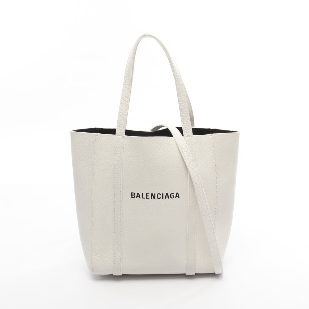 Balenciaga Everyday XXS 2WAY White: Authentic and authenticated Balenciaga Everyday XXS 2WAY tote handbag in white leather. Model 551815. Approx. 22H x 19W x 9D cm with 32 cm handle and 110-134 cm strap. Includes shoulder strap.