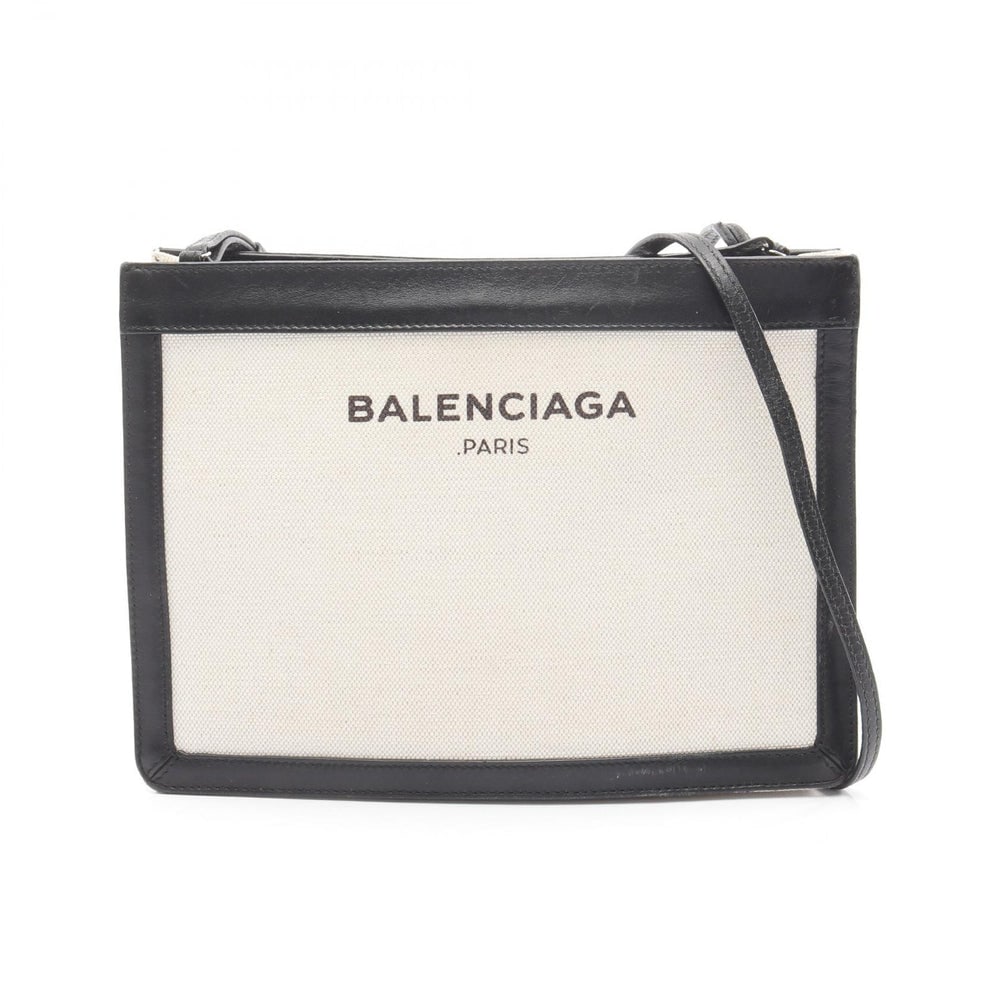 Balenciaga Navy Pochette Black: Balenciaga Navy Pochette Shoulder Bag. Color: Ivory Black. Material: Canvas Leather. Size: 26 X 18.5 X 4/3 Cm. Strap: 114-119 Cm.