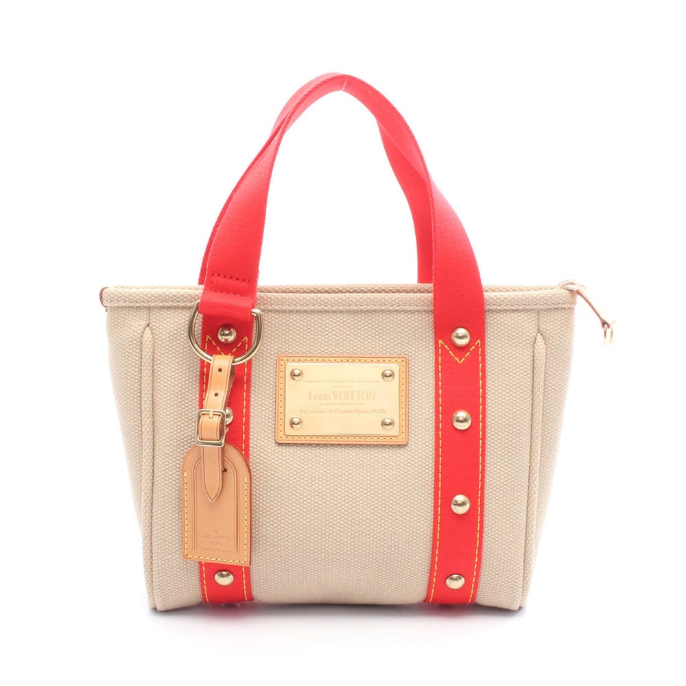 Louis Vuitton Antigua PM Tote: Beige and red canvas and leather tote. Model M40038. 24 x 20 x 5.5 cm.