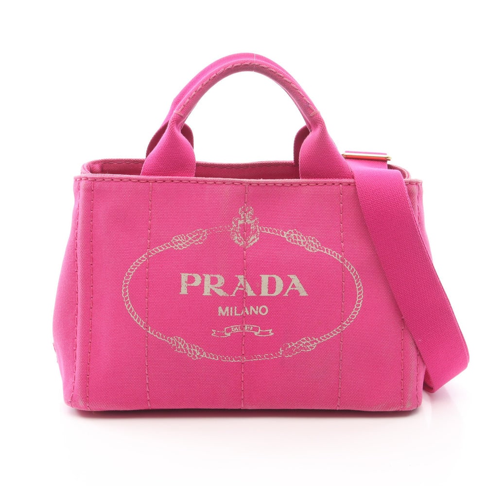 Prada Canapa Pink Canvas 2WAY Tote: Authentic and authenticated Prada Canapa 2WAY tote handbag in pink canvas. Model 1BG439. Approx. 19H x 29W x 14D cm with 25 cm handle and 74-128 cm strap. Includes shoulder strap.