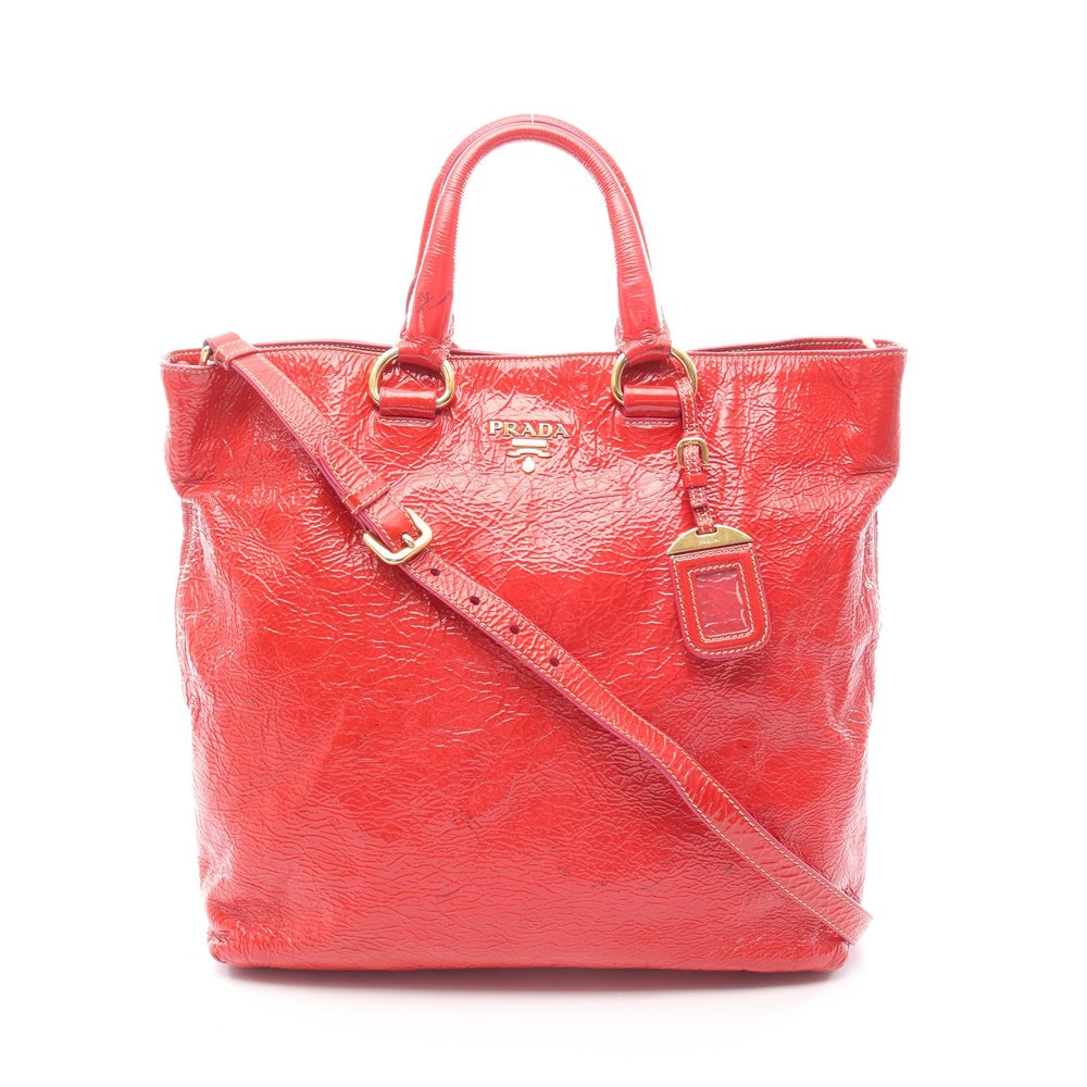 Prada Patent 2Way Tote Red: Prada Handbag Tote Bag. Color: Red. Material: Patent Leather. Size: 41/34.5 X 34 X 12 Cm. Handle: 35 Cm. Strap: 86-96 Cm. Includes: Shoulder Strap, Name Tag.