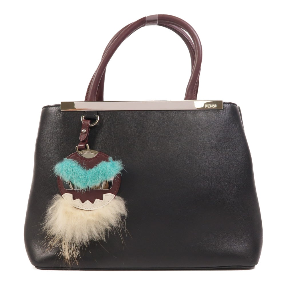 Fendi Monster Petite 2 Jours Black: Authentic and authenticated Fendi Monster Petite 2 Jours handmade handbag in black calfskin. Product no. 10429. Approx. 27W x 20H x 13D cm with 32 cm handle. Includes storage bags.