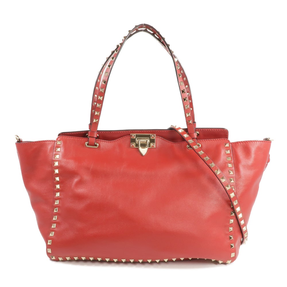 Valentino Rockstud 2 Way Tote Red: Authentic and authenticated Valentino Rockstud tote 2 way shoulder bag in red leather. Product no. BL-L970B0L2. Approx. 33W x 26H x 13D cm with 45 cm handle and 105 cm strap. Includes storage bags