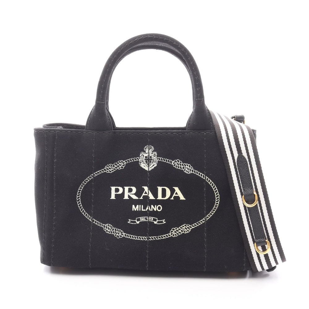 Prada Canapa 2Way Tote Black: Authenticated genuine Prada CANAPA 2WAY handbag tote in black canvas, model 1BG439. Includes shoulder strap and guarantee card. Approx. H19 x W28 x D14 cm with 32.5 cm handle.