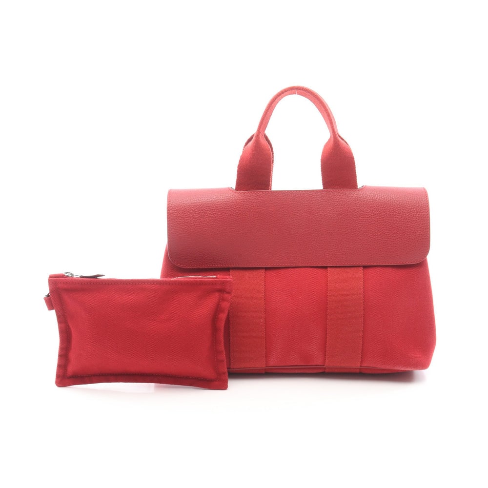 Hermes Valparaiso PM Red Handbag: Authentic and authenticated Hermes Valparaiso PM handbag in red toile chevron and vache liegee leather with silver hardware. Includes pouch. ?J stamp, around 2006. Approx. 21 x 28/30 x 14 cm.