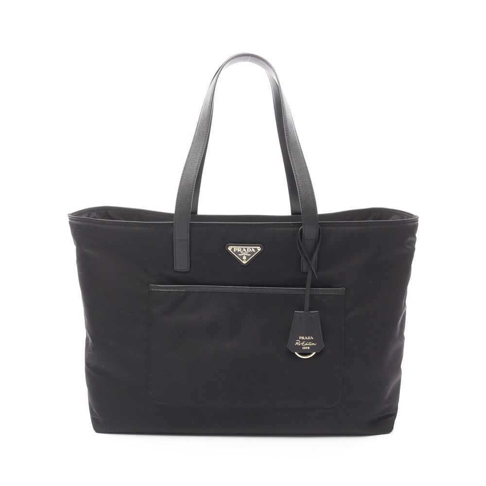 Prada Re-Edition 1978 Tote: Black nylon and leather tote shoulder bag; includes crochet key ring and storage bags; H31 x W51/42 x D15 cm; strap 56 cm. Authentic and authenticated.