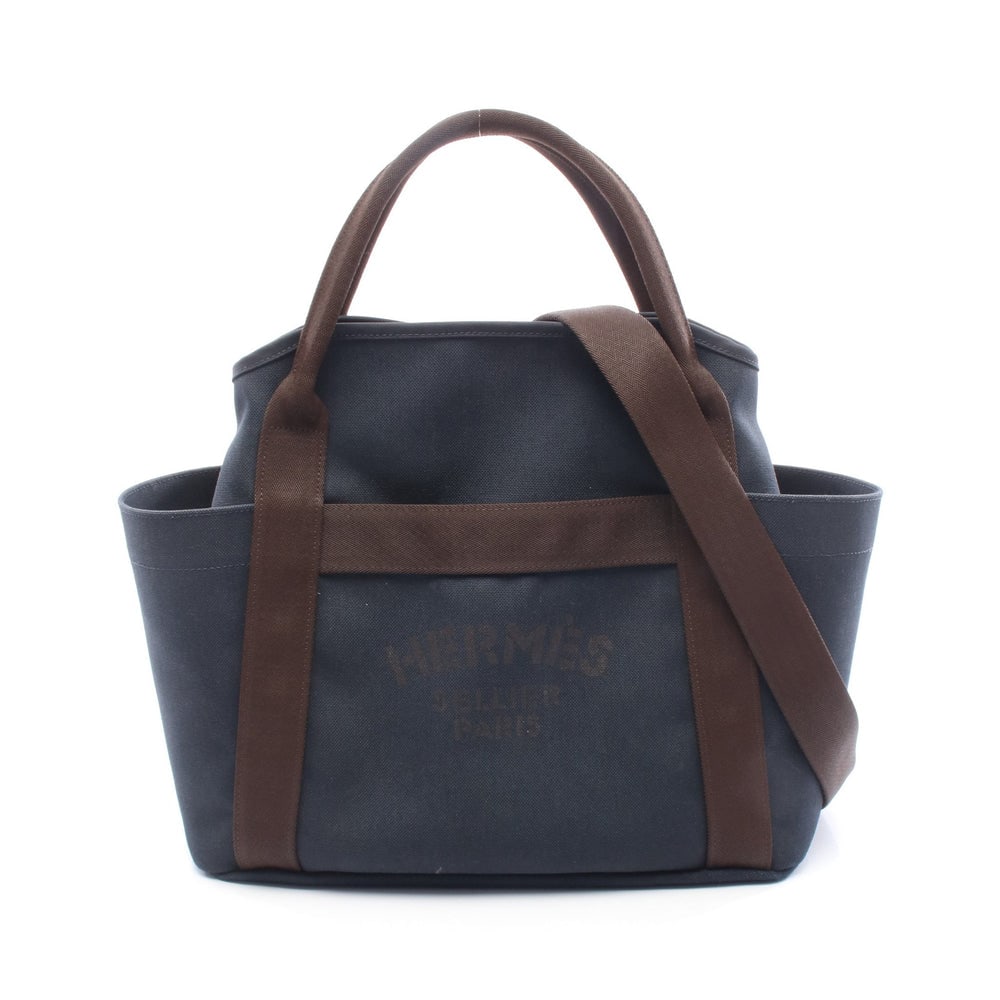 Hermes Sac De Pansage Groom: Navy and dark brown toile military and toile chevron 2 way tote; includes shoulder strap and inner bag; H35 x W40/38 x D15 cm. Authentic and authenticated.