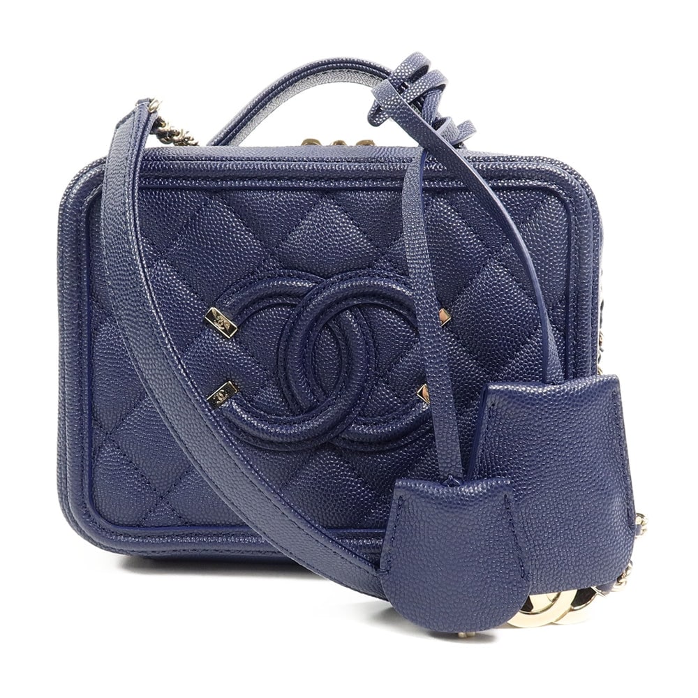 Chanel Filigree Vanity Navy: Navy calfskin CC Filigree vanity case with chain strap and gold-tone hardware.