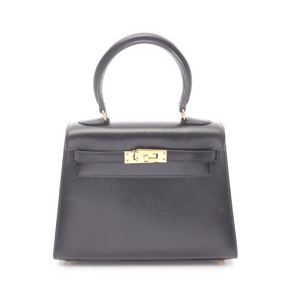 Hermes Mini Kelly Black: Black box calf outside sewing 2Way handbag with gold hardware. Includes shoulder strap. 20 x 14.5 x 9 cm.