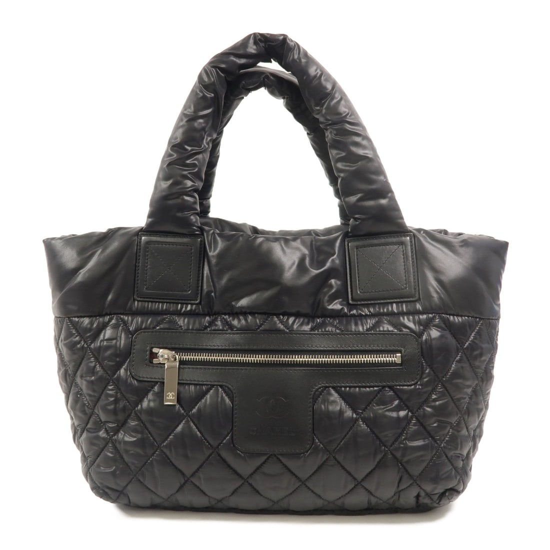 Chanel Coco Cocoon Tote Black: Authentic and authenticated Chanel Coco Cocoon tote bag in black nylon. Product no. 23362916. Approx. 29-43W x 26H x 15D cm with 38 cm handle. Includes hologram sticker and guarantee.