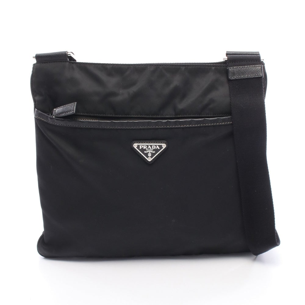 Prada Tessuto Saffiano Black: Prada Tessuto + Saffi Shoulder Bag. Color: Black. Material: Nylon Saffiano Leather. Size: 28/30 X 27 X 2 Cm. Strap: 75-127 Cm. Includes: Guarantee Card.