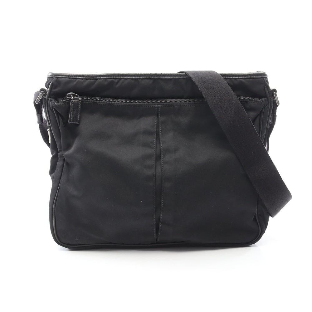 Prada Nylon Saffiano Shoulder Bag: Authentic and authenticated Prada shoulder bag in black nylon and saffiano leather with Prada logo plate. Approx. 27H x 31W x 2/6D cm with 74-133 cm strap. No accessories listed.