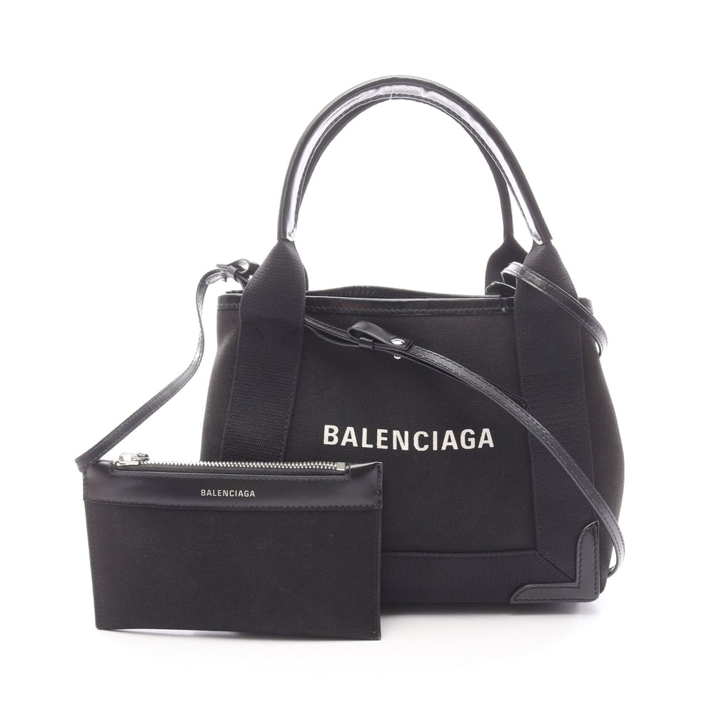 Balenciaga Navy XS Canvas Handbag: Authentic and authenticated Balenciaga Navy hippopotamus XS handbag in black canvas leather. Model 390346. Approx. 20H x 23/25W x 7D cm with 37 cm handle and 107-112 cm strap. Includes shoulder strap