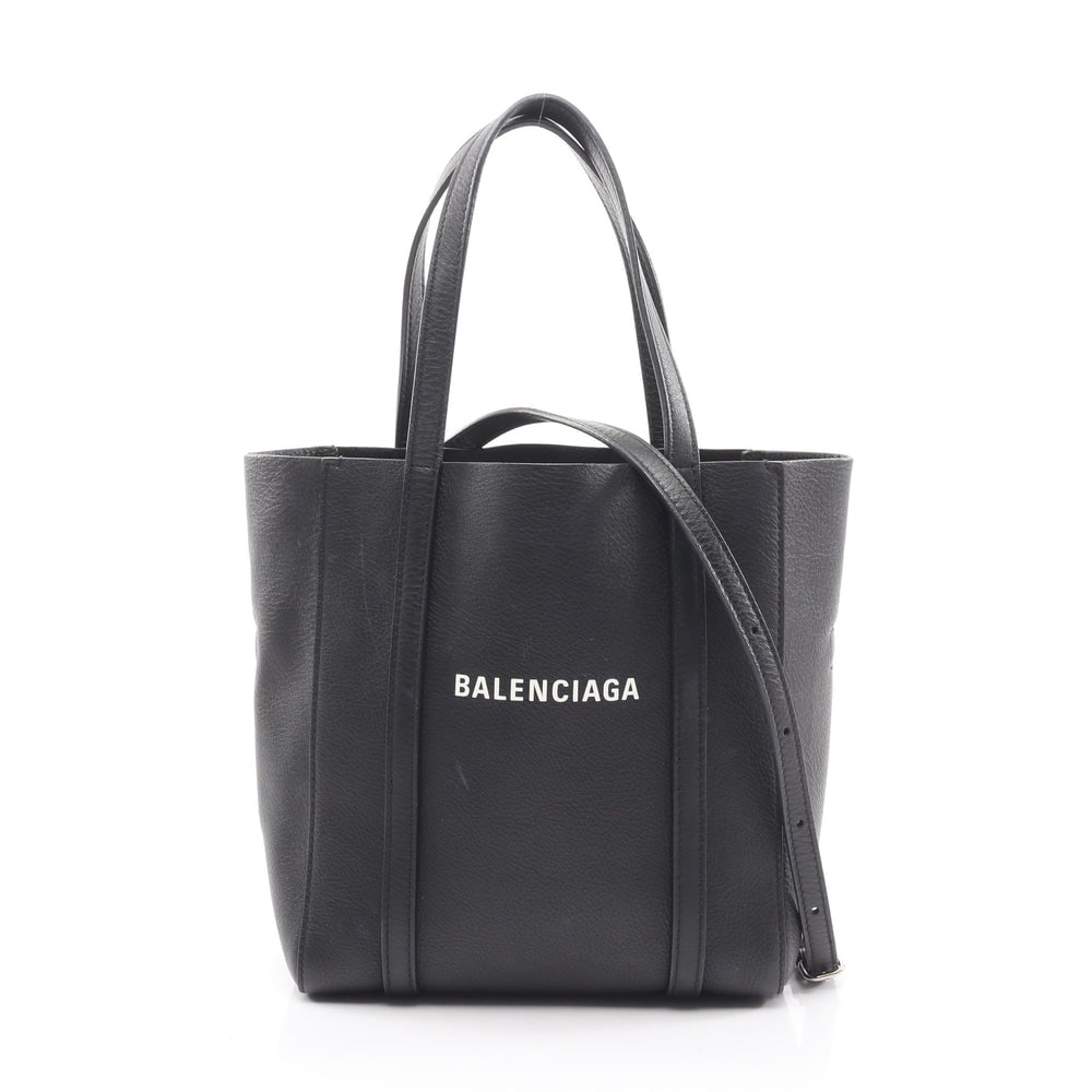 Balenciaga Everyday XXS 2WAY Black: Authentic and authenticated Balenciaga Everyday XXS 2WAY tote handbag in black leather. Model 551815. Approx. 22H x 19W x 9D cm with 32 cm handle and 110-134 cm strap. Includes shoulder strap.