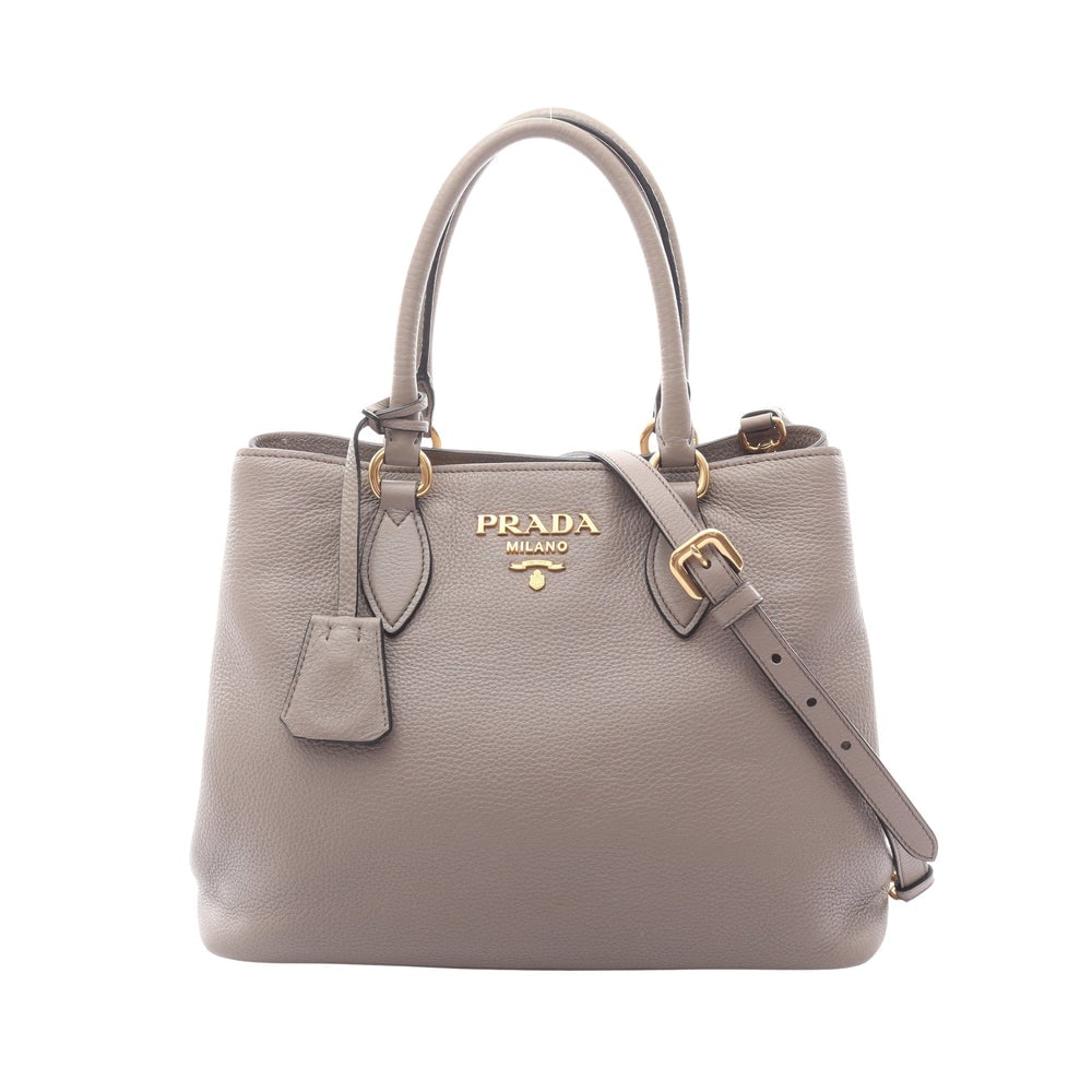 Prada Vitello Daino 2Way Bag: Authenticated genuine Prada Vitello Dino 2WAY handbag in gray beige leather. Includes shoulder strap and crochet with key ring. Approx. H23 x W27 top/30 base x D14.5 cm.