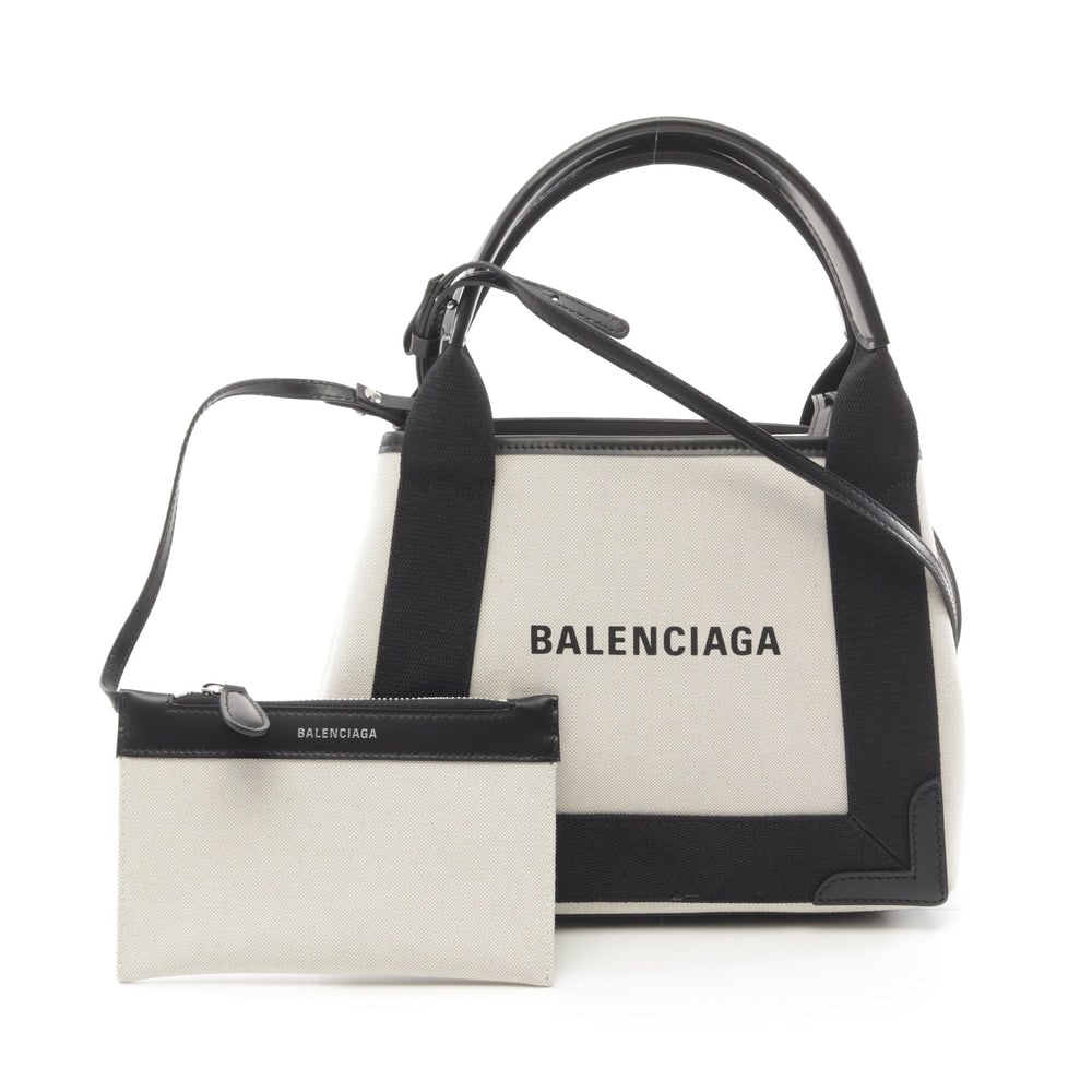 Balenciaga Navy XS 2Way Ivory: Ivory and black canvas and leather handbag. Includes shoulder strap and pouch. 25 x 20 x 7 cm.