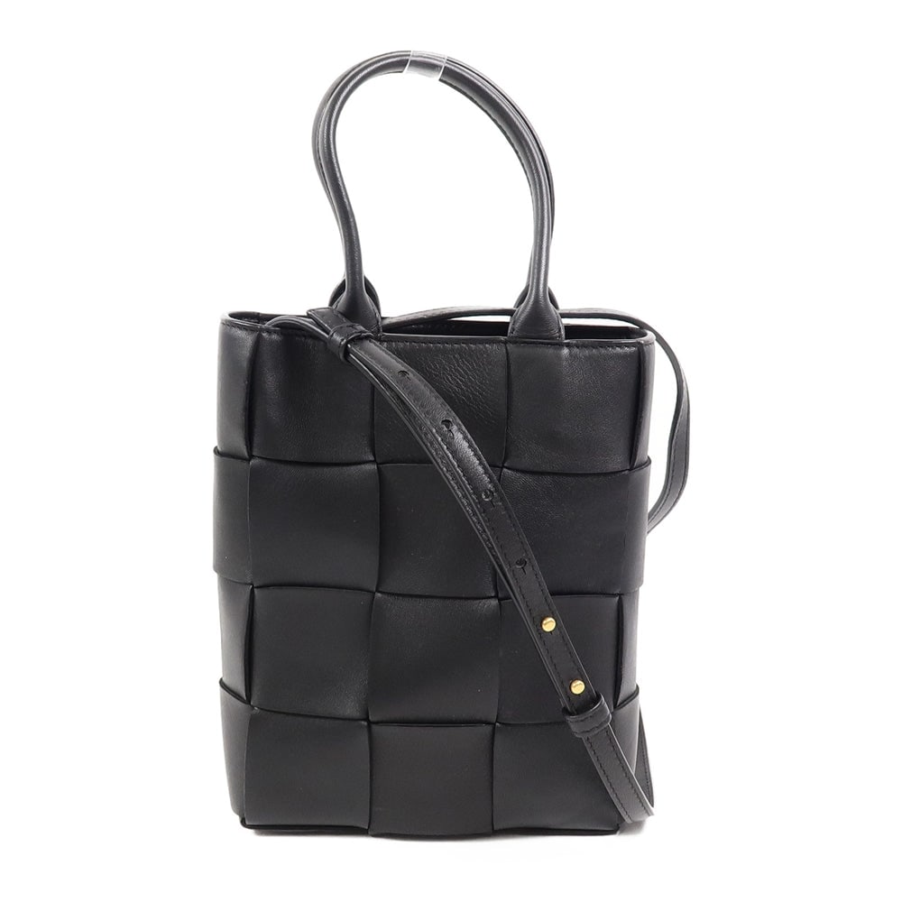 Bottega Mini Cassette 2 Way Black: Mini Cassette 2 way shoulder bag in black lambskin. Includes storage bags and shoulder strap. Size 18 x 21 x 5.5 cm.