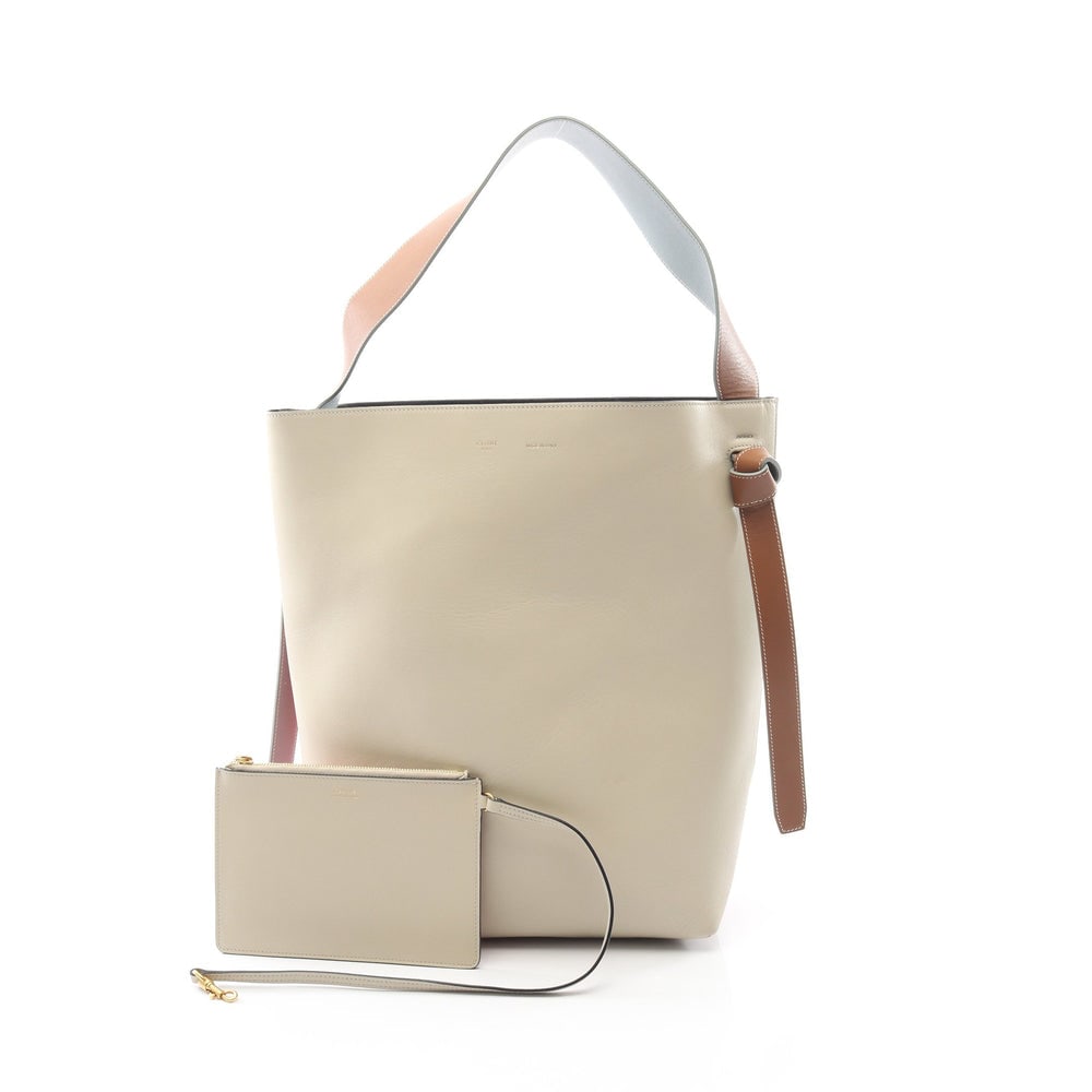 Celine Twisted Hobo Small Bag: Authentic and authenticated Celine Twisted Hippopotamus Small one shoulder bag in ivory, orange red, light blue leather. Model 177053. Includes pouch. Approx. 36.5 x 31/26 x 12.5 cm.
