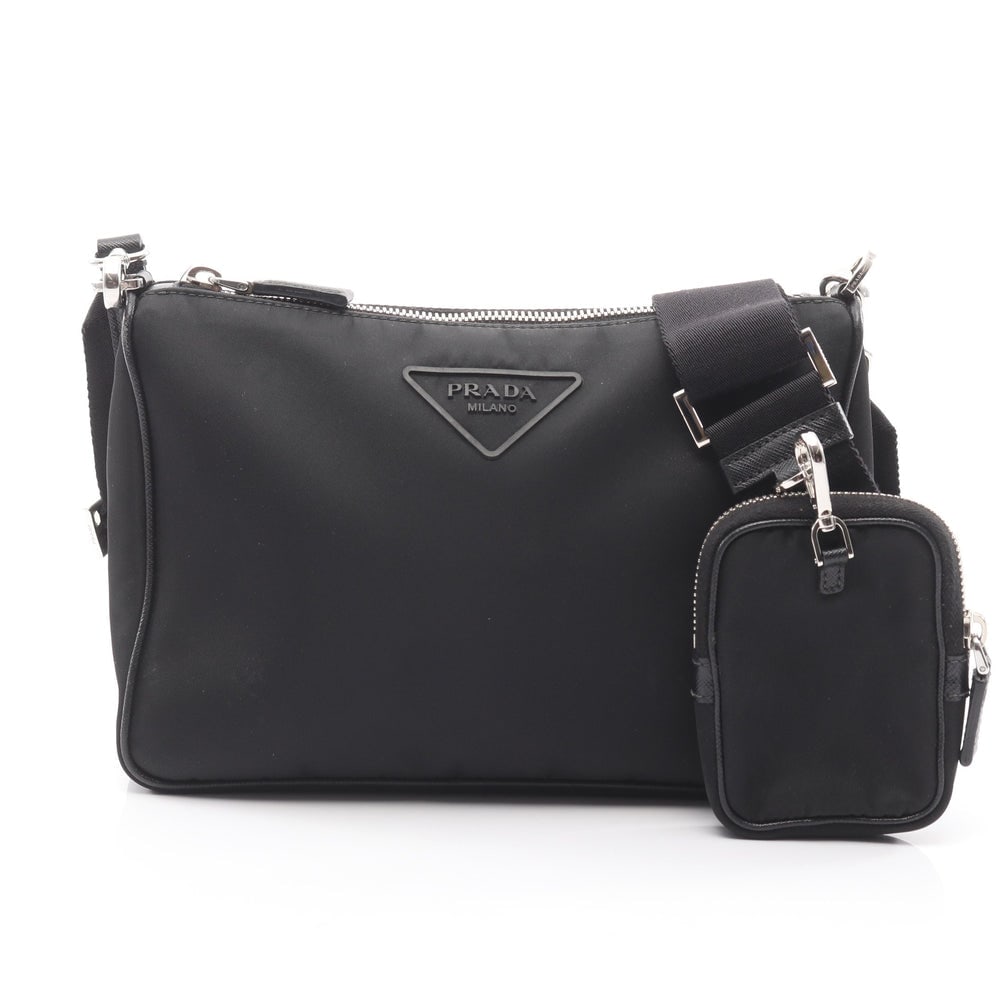 Prada Nylon Saffiano Shoulder Black: Black nylon and Saffiano leather Prada shoulder bag with pouch. Approx. 23.5 x 16.5 x 5.5 cm; strap 97-142 cm. Model 2VH113. Authentic and authenticated.
