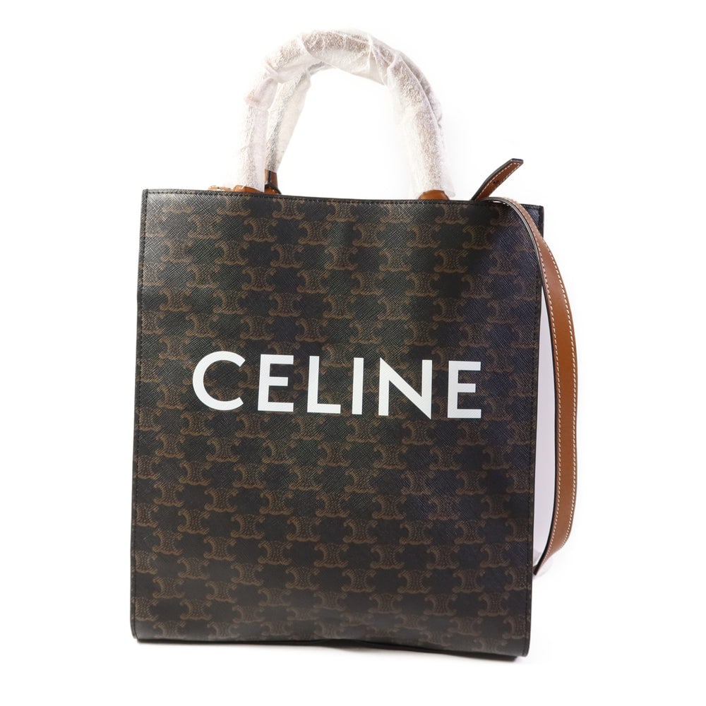 Celine Triomphe Cabas 2-Way Brown: Brown PVC coated canvas Celine Triomphe Cabas tote 2-way shoulder bag with storage bags. Approx. 27.5 x 32 x 7.5 cm; handle 31 cm; strap 104-106 cm. Authentic and authenticated.