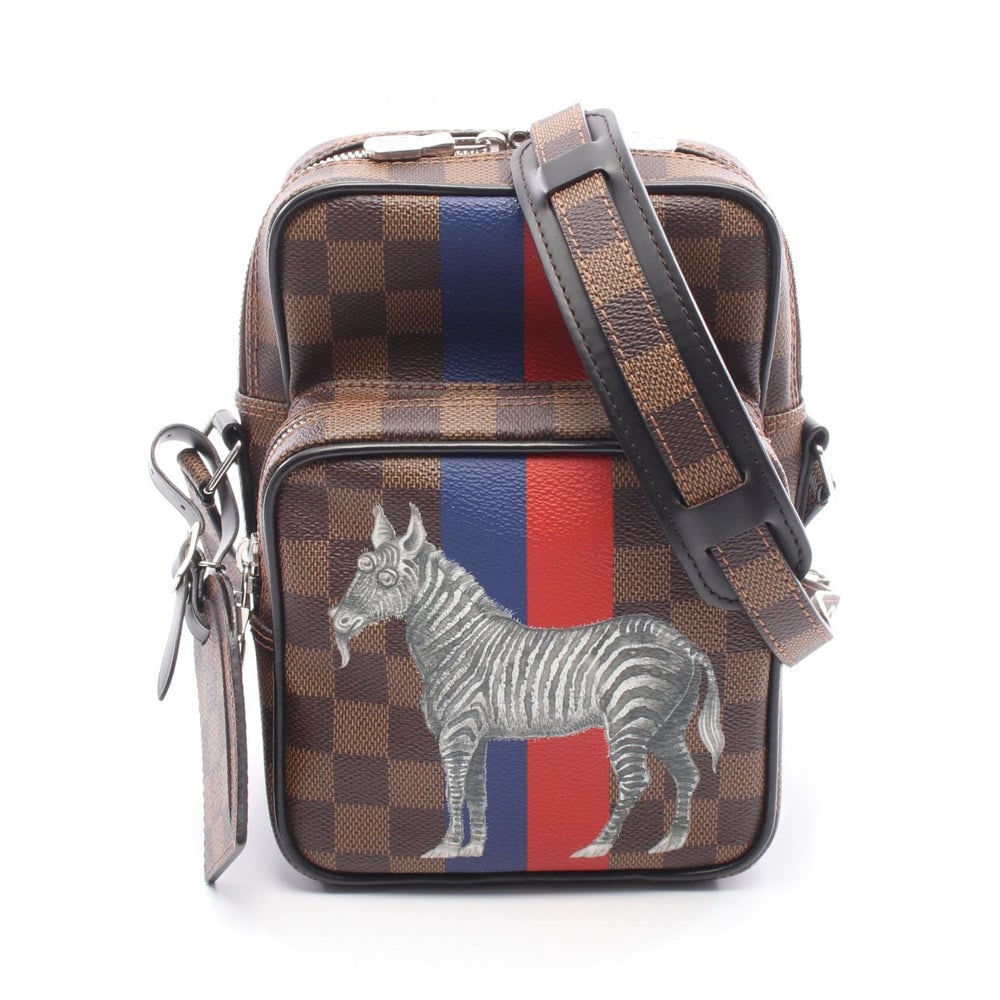 LV Amazon Damier Savanna Brown Black: Brown, black, and multicolor PVC leather Amazon Damier Savanna shoulder bag with name tag. Approx. 15 x 21 x 4.5/5.5 cm; strap 116-134 cm. Model N42703, product no. TR4166. Authentic and