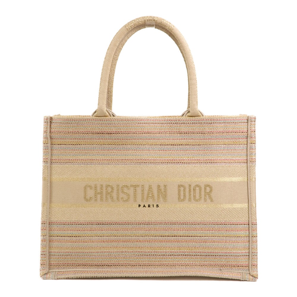 Dior Book Tote Medium Beige: Beige canvas Dior Book Tote Medium hand bag with storage bags. Approx. 36 x 27.5 x 16.5 cm; handle 41 cm. Product no. 50-MA-0211. Authentic and authenticated.