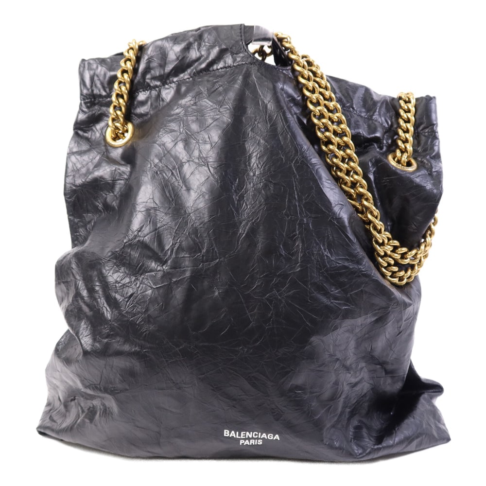 Balenciaga Crush Medium Chain Black: Black lambskin Balenciaga Crush Medium chain shoulder bag with storage bags. Approx. 35.5 x 14 x 38 cm; strap 68-131 cm. Authentic and authenticated.