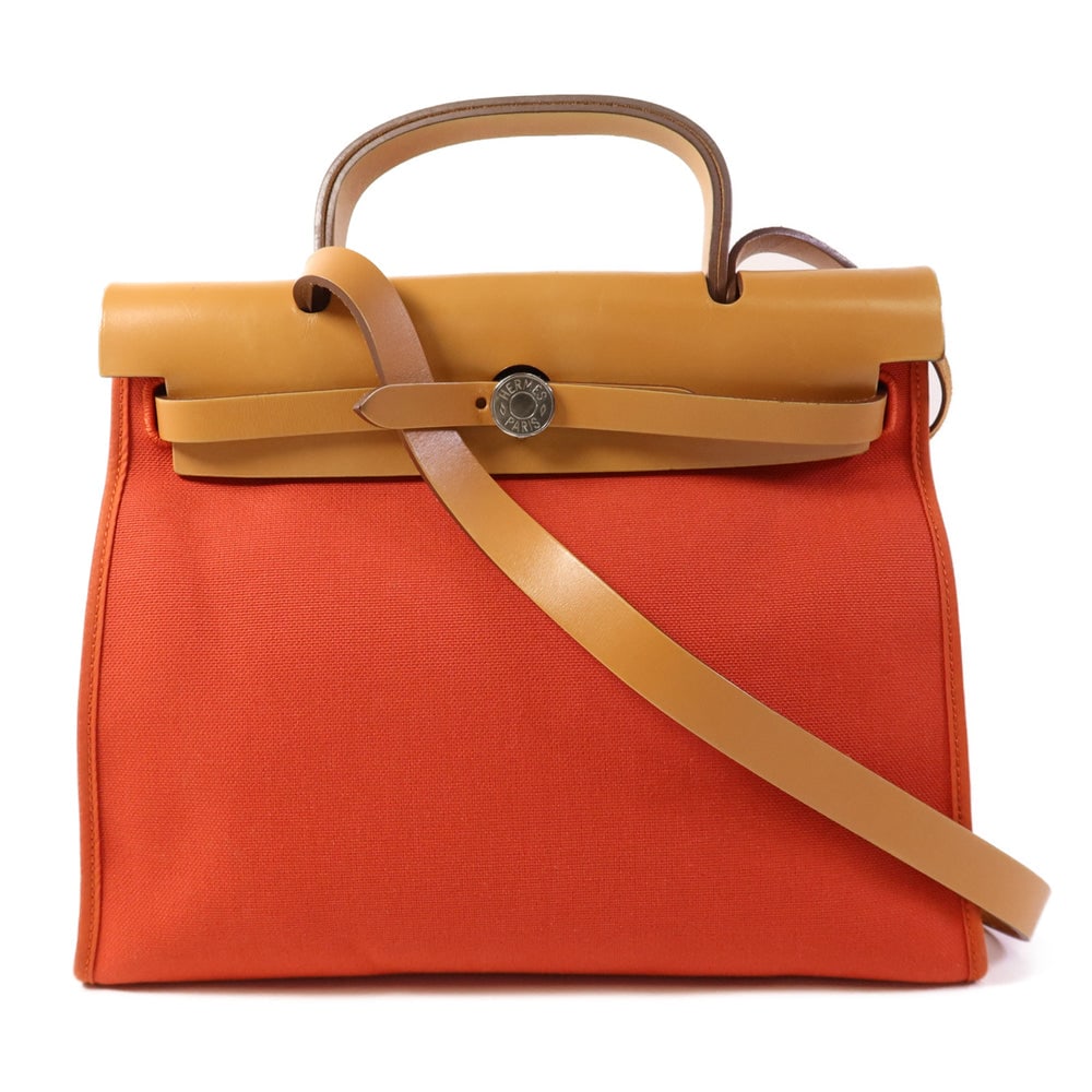 Hermes Herbag PM 2 Way Bag: Red canvas 2 way shoulder bag with SHW; includes storage bag and pouch; W31 x H25 x D10 cm; handle 23 cm. Authentic and authenticated.