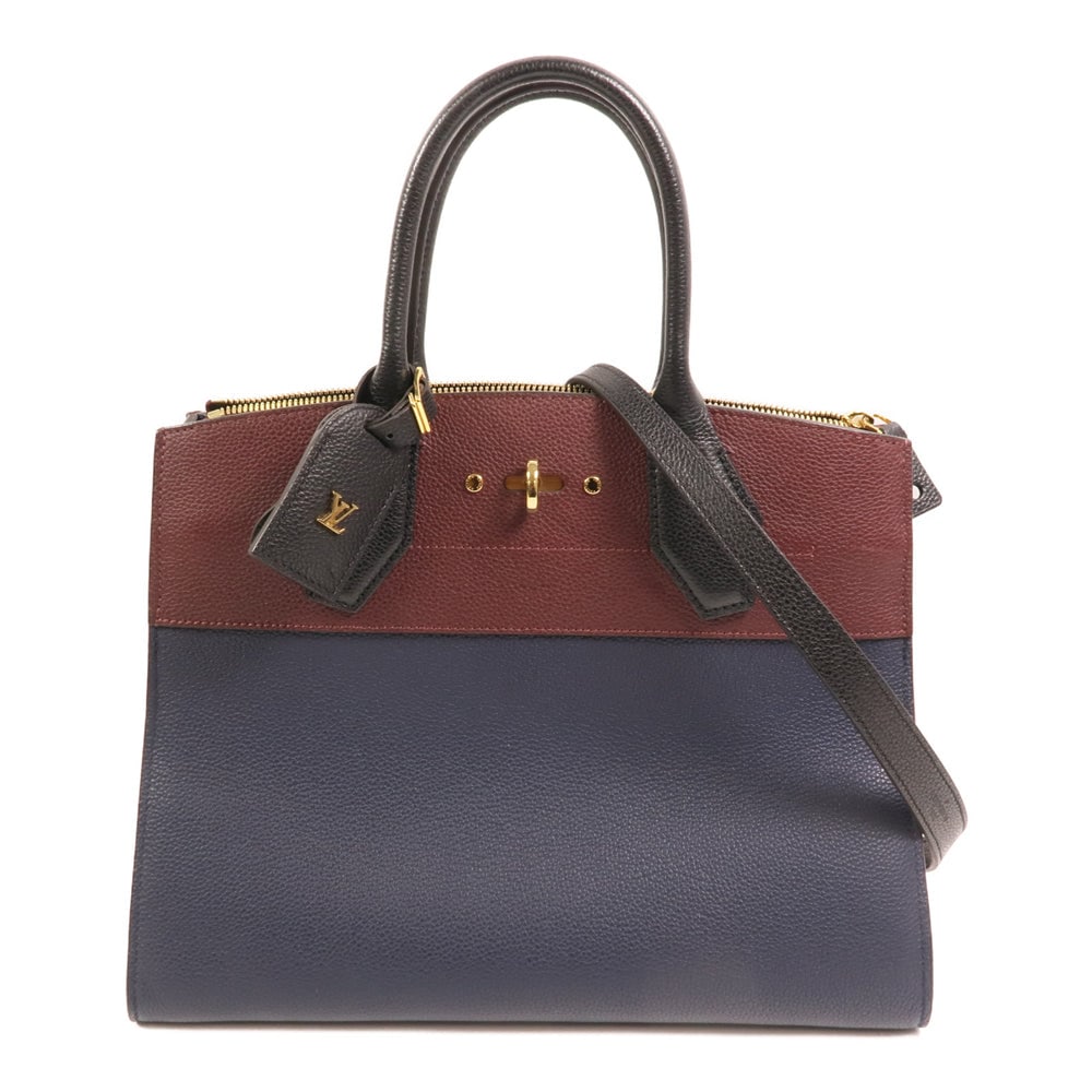 Louis Vuitton City Steamer MM: Blue and red taurillon clemence calfskin 2 way shoulder bag with GHW; includes storage bag key padlock and name tag; W31 x H24 x D14 cm. Authentic and authenticated.