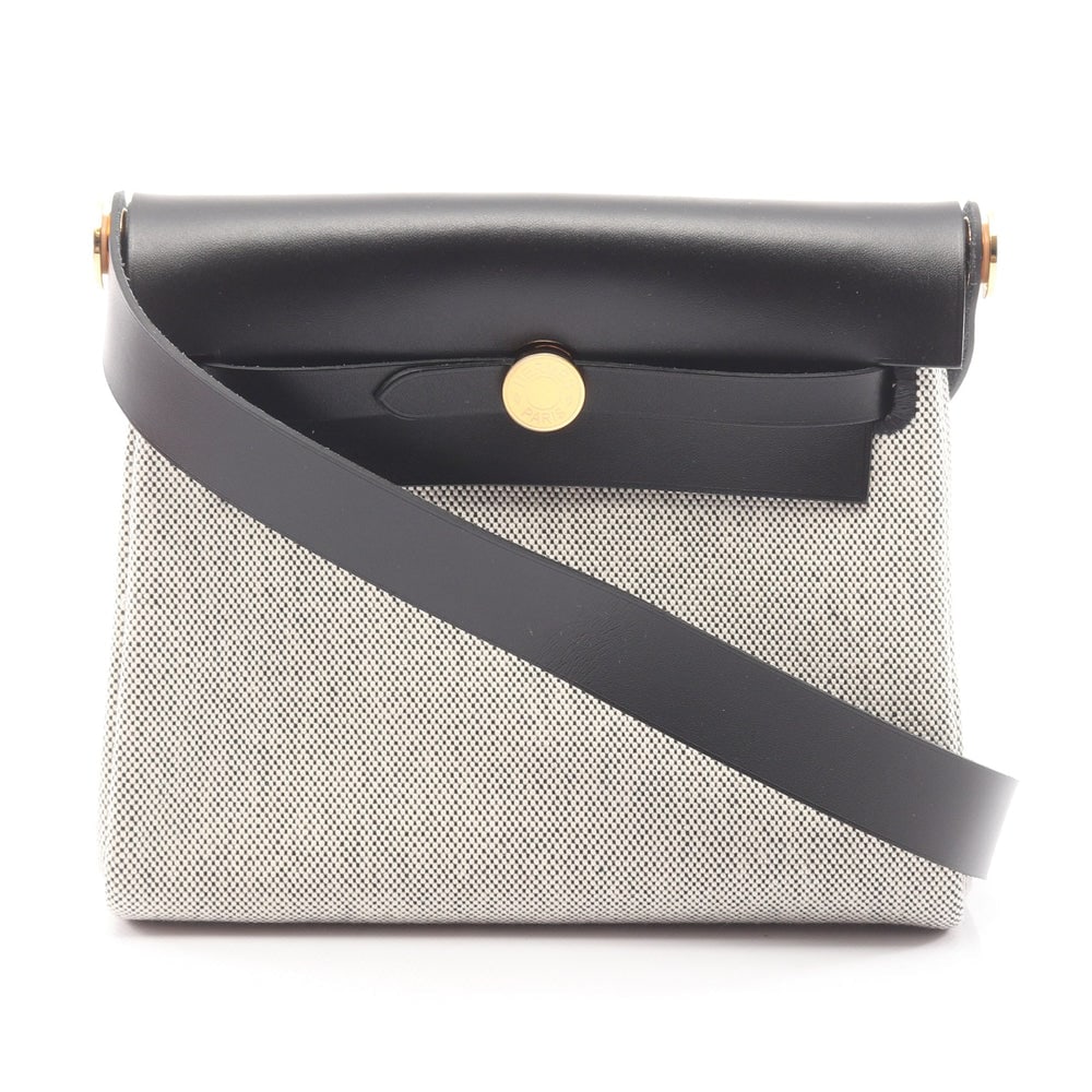 Hermes Herbag Zip Mini Ecru Black: Light grey and black Toile H canvas and Vache Hunter shoulder bag with gold-tone hardware.