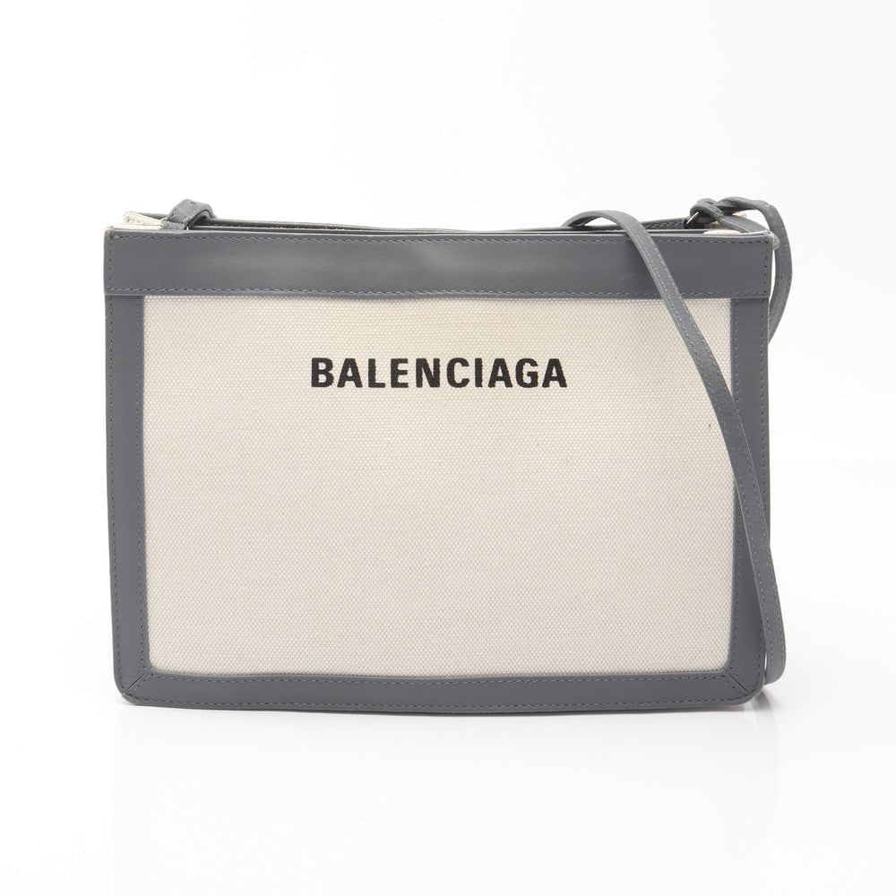 Balenciaga Navy Pochette Gray: Balenciaga Navy Pochette Shoulder Bag. Color: Ivory Gray. Material: Canvas Leather. Size: 26 X 18.5 X 4/3 Cm. Strap: 114-119 Cm.