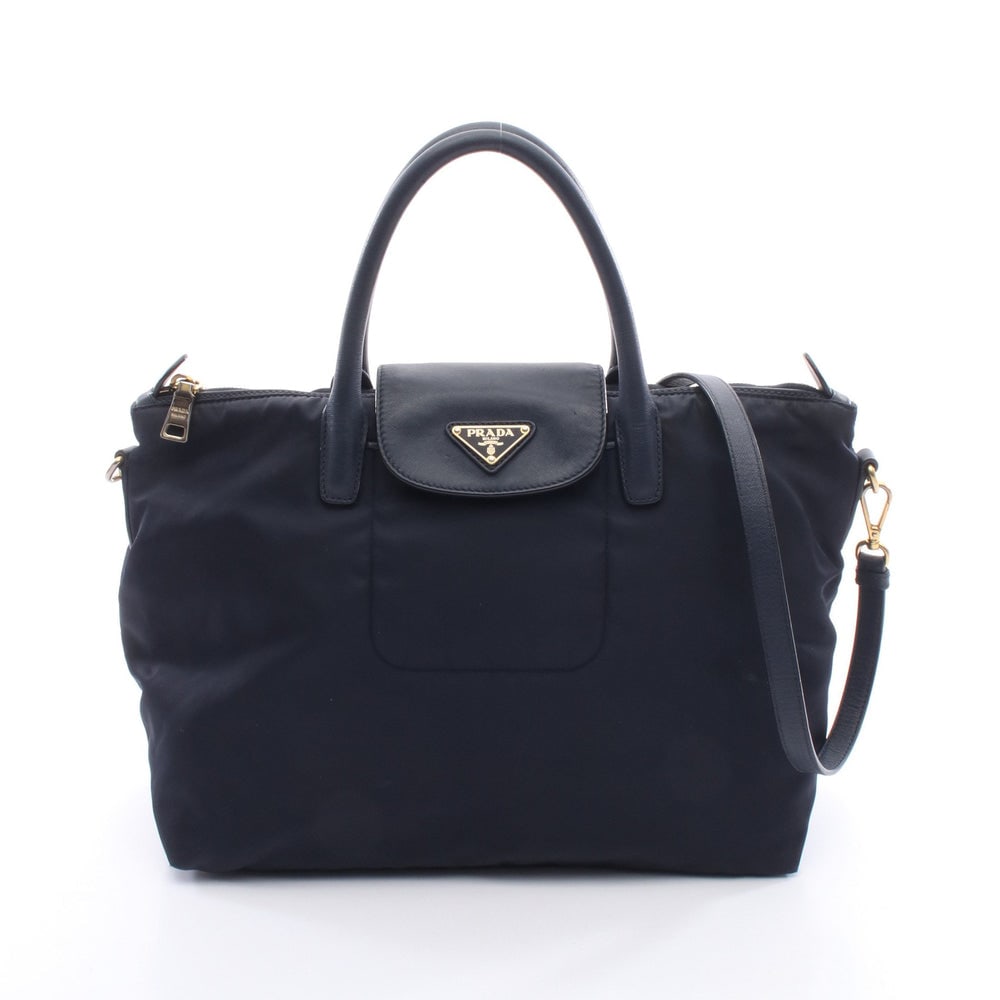 Prada 2Way Nylon Handbag Navy: Prada 2Way Handbag. Color: Navy. Material: Nylon Saffiano Leather. Size: 37/33 X 27 X 18 Cm. Handle: 42 Cm. Strap: 97-126 Cm. Includes: Shoulder Strap.