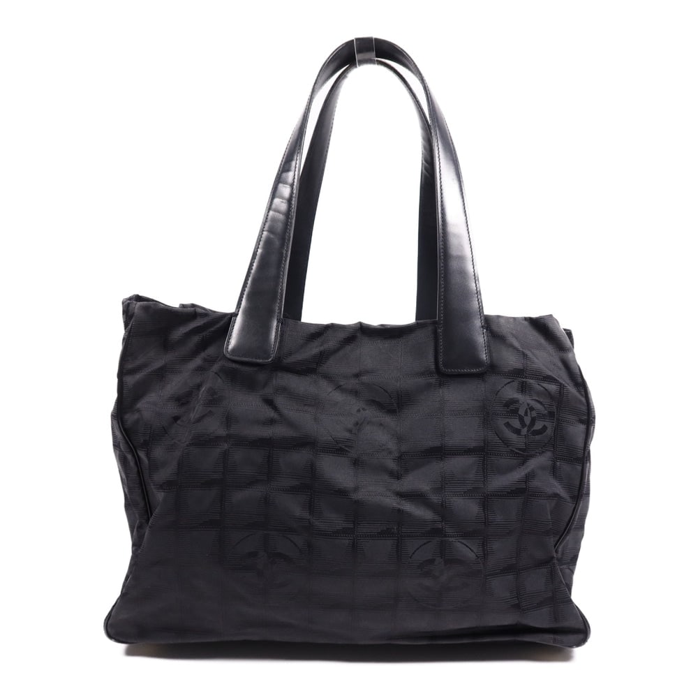 Chanel New Travel Line Tote Black: Authentic and authenticated Chanel New Travel Line tote bag in black nylon. Approx. 35W x 25H x 15D cm with 51 cm handle. No accessories listed.