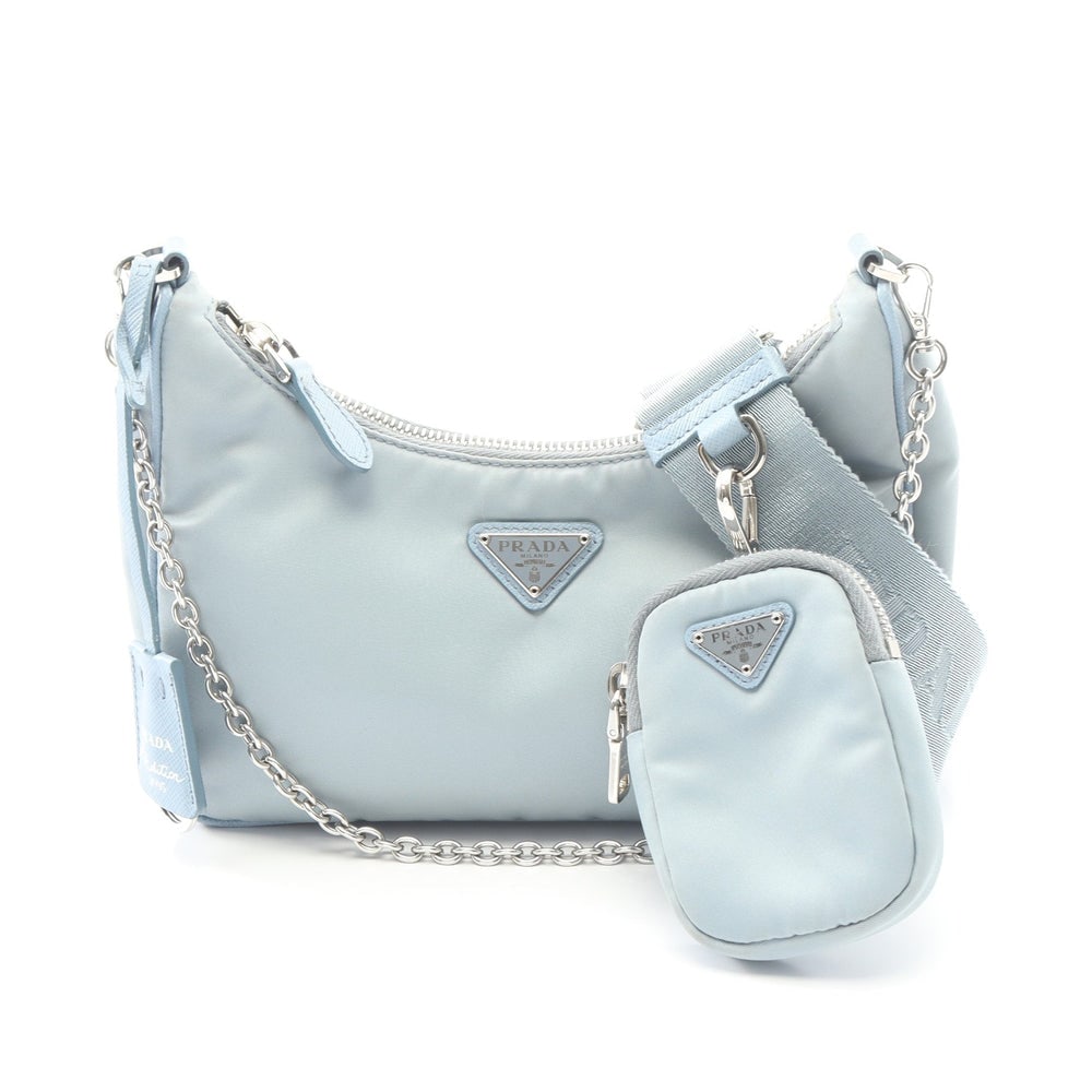 Prada Re-Edition 2005 Chain 2Way: Authentic and authenticated Prada Re-Edition 2005 chain shoulder bag in light blue nylon and saffiano leather. Model 1BH204. Includes long strap, key ring crochet, and guarantee card.