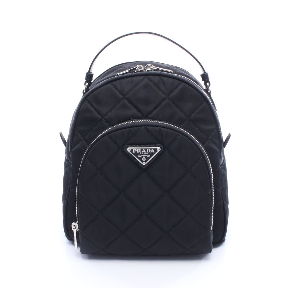 Prada Tessuto Impuntu Backpack Black: Black nylon and leather Tessuto Impuntu backpack with guarantee card. Approx. 21 x 23.5 x 11 cm; straps 58-73 cm; handle 31 cm. Model 1BZ066. Authentic and authenticated.