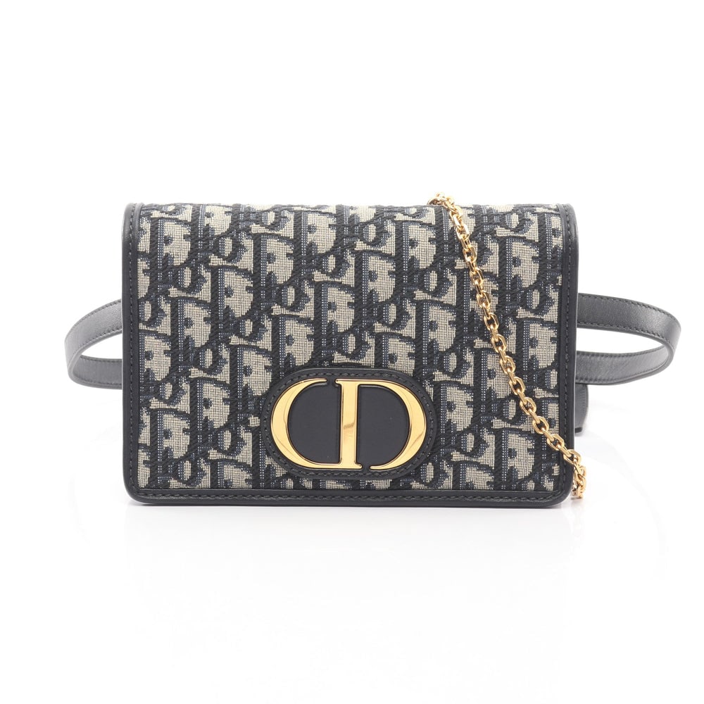 Dior 30 Montaigne 2-in-1 Body Bag: Light beige, navy, and black canvas and leather 30 Montaigne 2-in-1 body or waist bag. Includes chain shoulder strap. Approx. 19 x 12 x 3.5 cm; strap 60-80 cm. Authentic and authenticated.